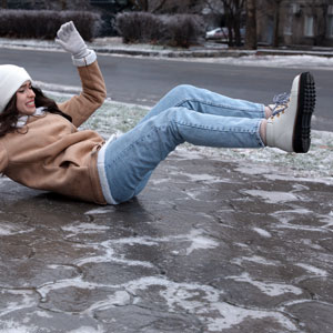 A woman laying on the ground after a slip and fall accident - Donnelly Law LLC