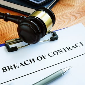 Illinois breach of contract law illustrated with gavel and legal document.